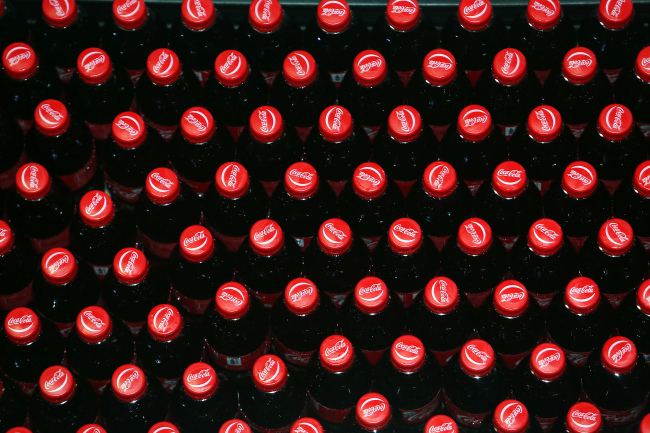 Bottles of Coca-Cola move along the production line at the Coca-Cola Co. bottling plant in Hmawbi, Myanmar.   Bloomberg
