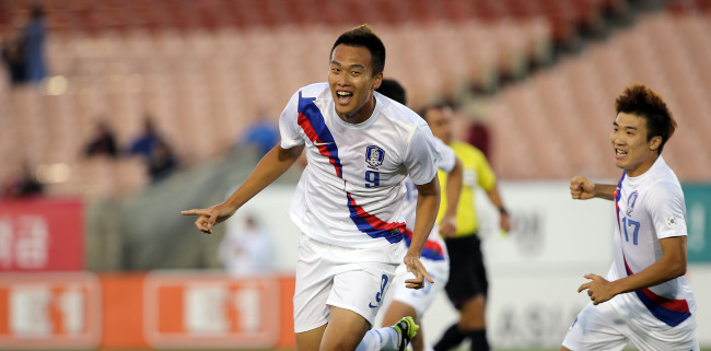 Korea striker Kim Shin-wook celebrates his goal in the 10th minute on Saturday.   Yonhap