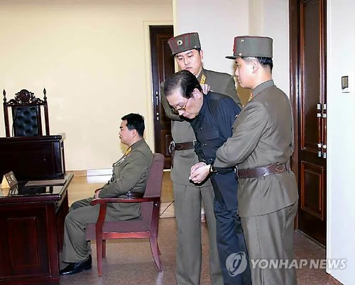 Jang Song-thaek (center) is escorted by military officers to his trial in December, 2013, prior to his execution. (Yonhap)