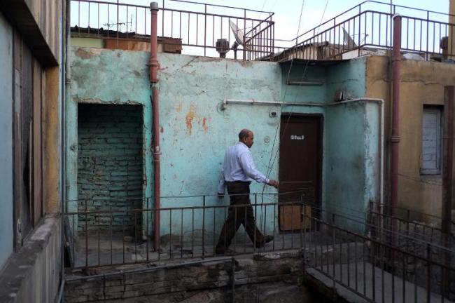 Shukri Mahmud walks along the rooftop where he lives with his family in Cairo.   AFP