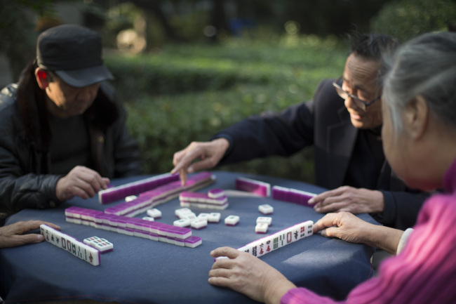 People play mahjong at Baotu Spring Park in Jinan, China.   Bloomberg