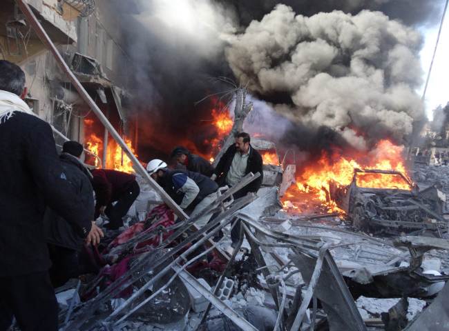 Medical personnel look for survivors following a reported air strike on the Tariq al-Bab district of the northern Syrian city of Aleppo on Saturday.   AFP-Yonhap