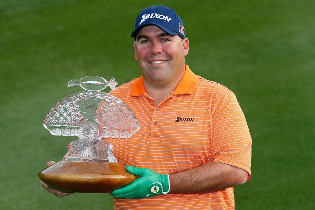 Kevin Stadler poses with the championship trophy after winning the Waste Management Phoenix Open on Sunday.   AFP-Yonhap