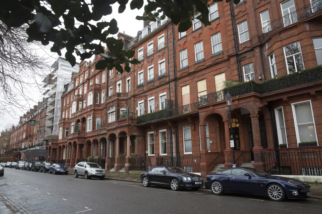 Automobiles sit parked in front of residential properties on Cadagon Square in London.   Bloomberg
