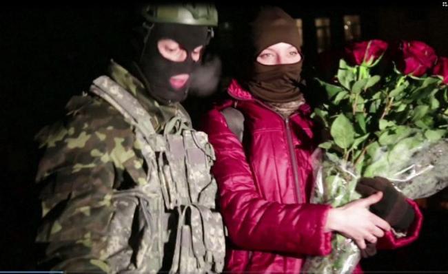 A protester (left) stands next to his girlfriend after making his wedding proposal in a street close to Independence Square, where the deadliest clashes broke out last month, in Kiev on Feb. 2.  AFP-Yonhap