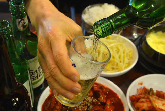 Korean somaek soju bomb cocktail with shot glass of soju dropped into beer glass