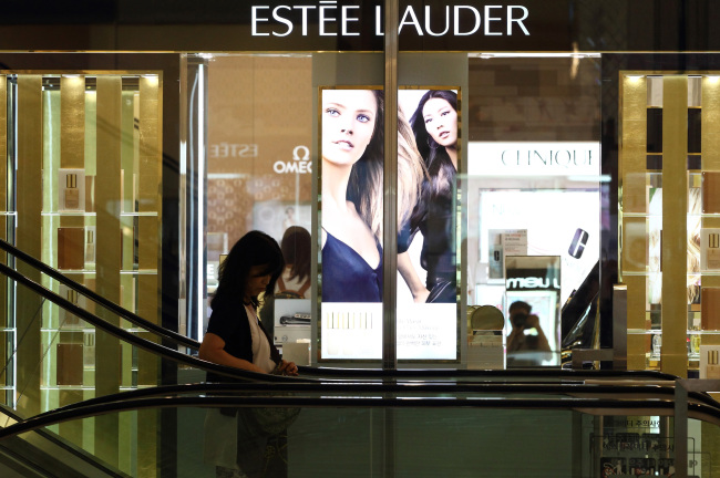 A customer enters the cosmetics section of a Seoul department store.   Bloomberg