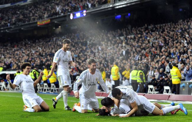 Real Madrid players celebrate after a goal on Wednesday.   AFP-Yonhap