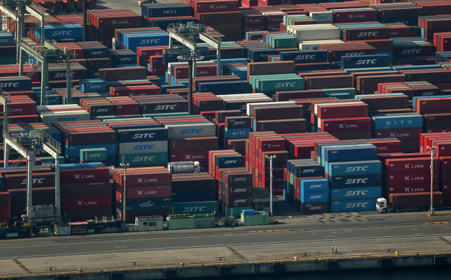 Shipping containers are stacked at the Oi Container Terminal in Tokyo.   Bloomberg