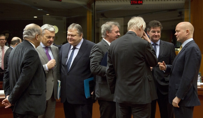 European Union foreign ministers speak with each other during a meeting in Brussels on Monday,  AP-Yonhap