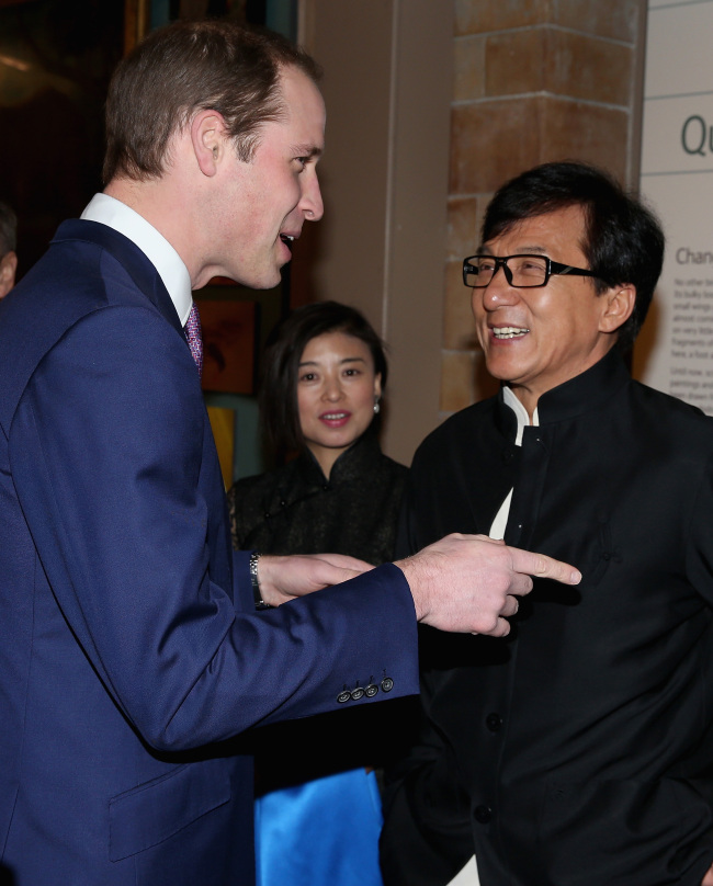 Prince William (left), Duke of Cambridge, meets actor Jackie Chan as he arrives at an evening reception for the Illegal Wildlife Trade conference at the Natural History Museum in London on Wednesday.   AP-Yonhap