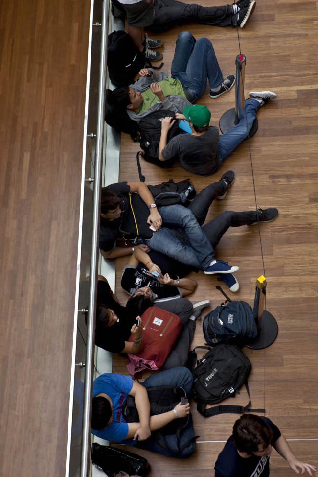 Customers wait in line for the opening of the first Apple Inc. store in Latin America, at the Village mall in Rio de Janeiro, Brazil, Saturday.   Bloomberg
