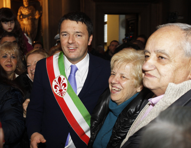 Florence Mayor Matteo Renzi (left) greets couples who have been married for over 50 years during a ceremony on Valentine’s Day in Florence, Italy.   AP-Yonhap