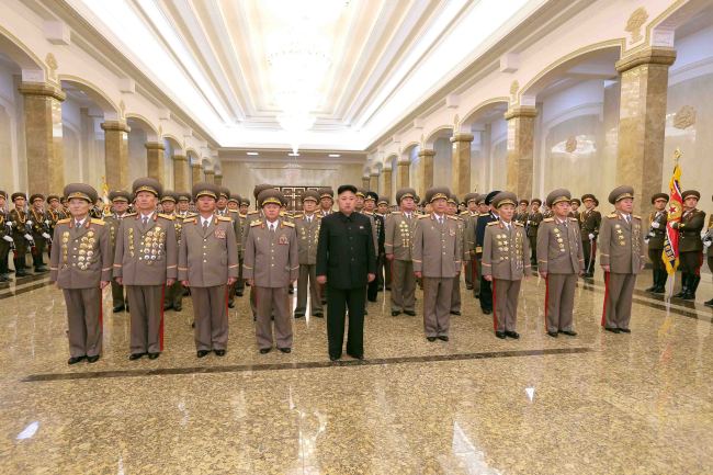 North Korean leader Kim Jong-un (center) and military leaders pay their respects at the Kumsusan Palace of the Sun in Pyongyang to mark the anniversary of the birth of late former ruler Kim Jong-il on Sunday. (Yonhap)