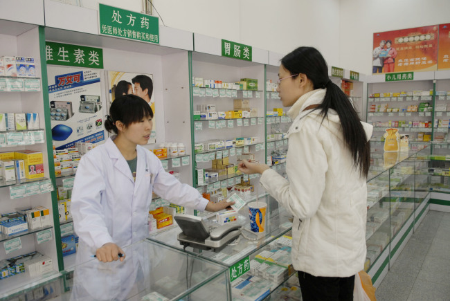 A shopper browses through a pharmacy in Beijing.   Bloomberg