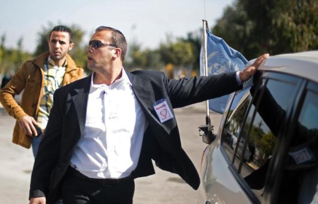 A guard from Gaza’s first private security company Secure Land is seen near the car carrying Palestinian singer and Arab Idol winner Mohammed Assaf during his visit to Palestine University in Gaza City.    AFP