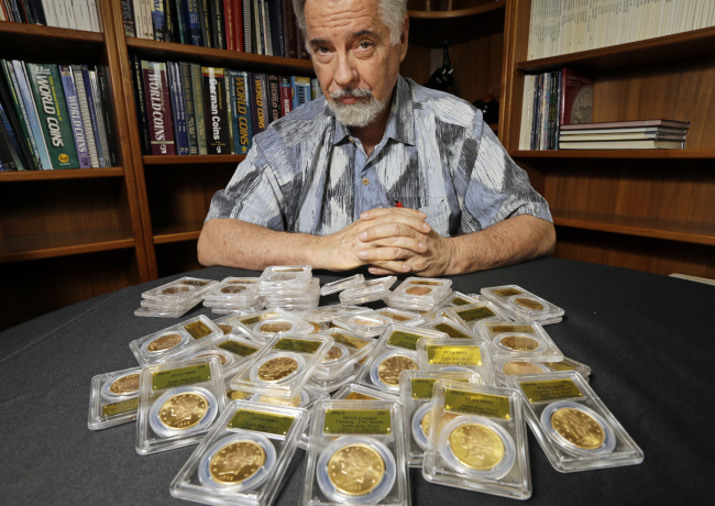 David Hall, co-founder of Professional Coin Grading Service, poses with some of 1,427 Gold-Rush era U.S. gold coins, at his office in Santa Ana, California, Tuesday.   AP-Yonhap