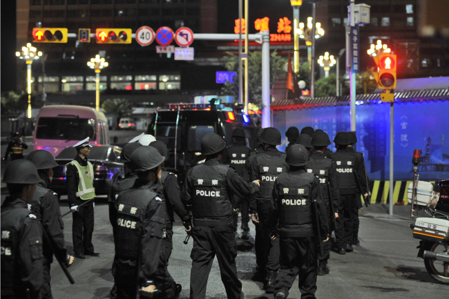 Police officers patrol outside Kunming Train Station after an attack by knife wielding men left 34 dead and some 130 injured in Kunming, in southwestern China's Yunnan province, Saturday March 1, 2014. (Photo: AP)