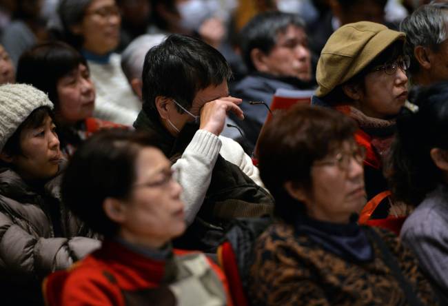 A man wipes tears as he listens to a speech at a rally in Tokyo on Saturday.   AFP-Yonhap