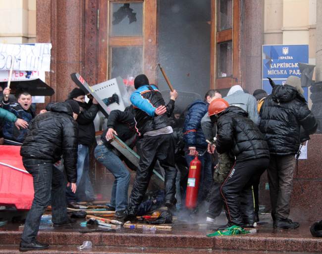 Pro-Russian activists clash with Maidan supporters as they storm the regional government building in Kharkiv on Saturday.   AFP-Yonhap