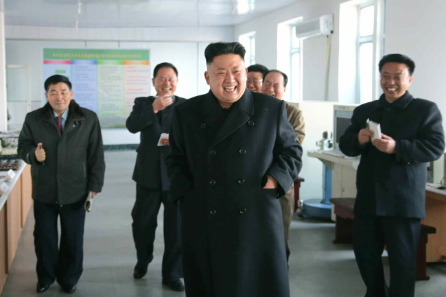 North Korean leader Kim Jong-un and officials take a group tour in a mechinary production facilities in Pyeongyang on Monday.