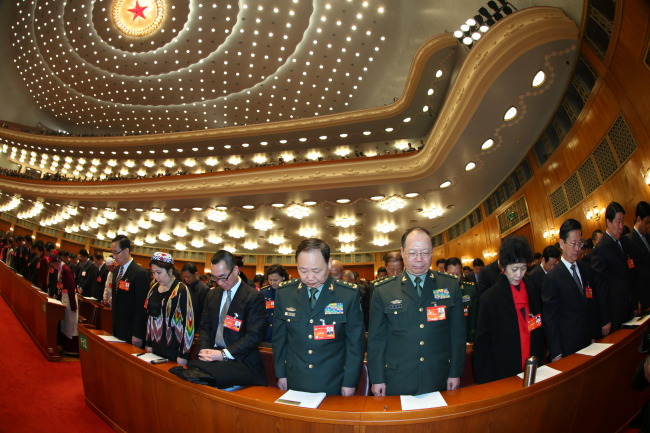 Members of the 12th National Committee of the Chinese People’s Political Consultative Conference pay silent tribute to the victims of the Saturday terrorist attack in southwestern city of Kunming, at the opening of the second session of the 12th National Committee of the CPPCC in Beijing on Monday.   Xinhua-Yonhap