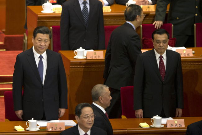 Chinese President Xi Jinping (left) and Chinese Premier Li Keqiang (right) attend the opening session of the Chinese People’s Political Consultative Conference in Beijing’s Great Hall of the People on Monday.   AP-Yonhap