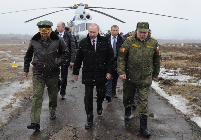 Russia's defence minister Sergei Shoigu, president Vladimir Putin, and commander of the Russian Western Military District Troops Anatoly Sidorov (L-R) arrive at the Kirillovsky training ground to watch military exercises. (ITAR-TASS-Yonhap)