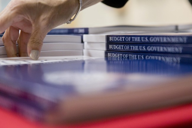 A Government Printing Office staff member arranges copies of U.S. President Barack Obama’s 2015 budget at the GPO bookstore in Washington, D.C., Tuesday.   Bloomberg