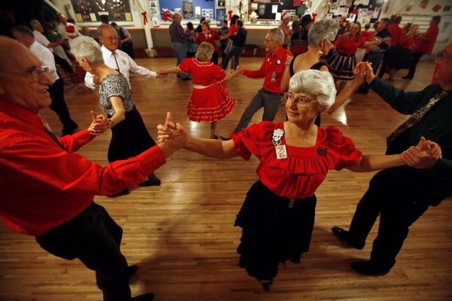 Bob Soman (left), Cathy Emery (center) and Bruce Turner, dance together during the last dance of the night at Cowtown Square Dance Center in Riverside, California.   Los Angeles Times/MCT