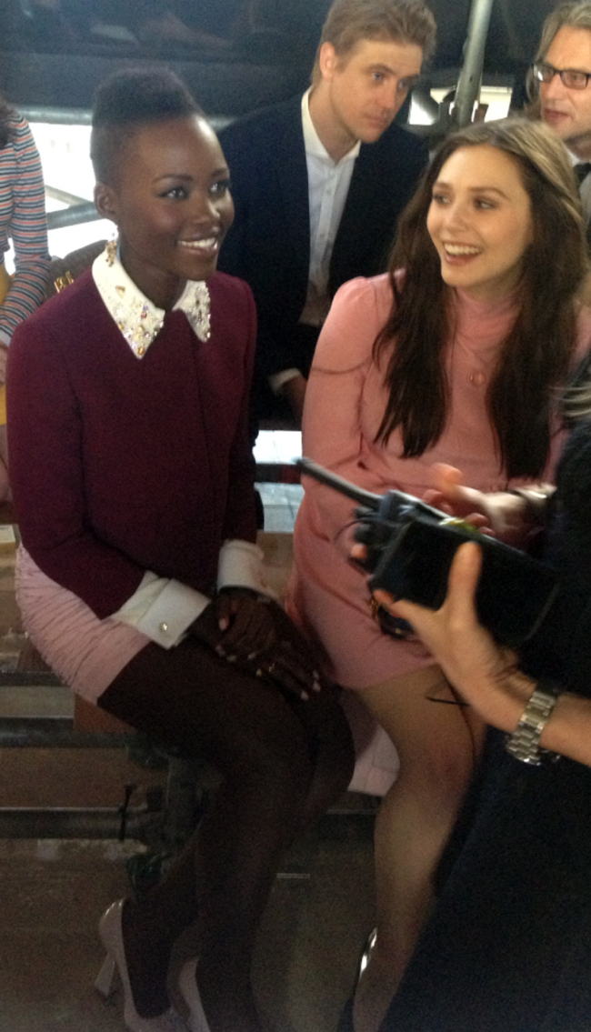 Actresses Lupita Nyong’o (left) and Elizabeth Olsen attend Miu Miu’s ready to wear fall/winter 2014-2015 fashion collection presented in Paris, Wednesday. AP-Yonhap