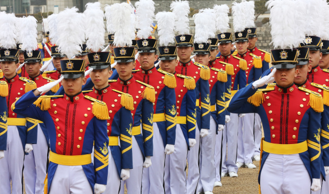 Army cadets salute during their commencement ceremony at the Korea Military Academy in northern Seoul on Feb. 27.   Yonhap