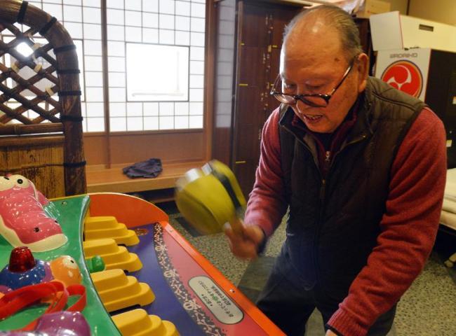 Saburo Sakamoto plays a game at Kaikaya Ltd., a nursing home for the elderly in Yokohama, suburban Tokyo. (AFP)