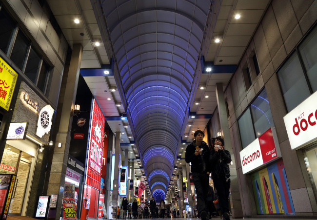 Pedestrians walk along a shopping street in Sendai, Japan.   Bloomberg
