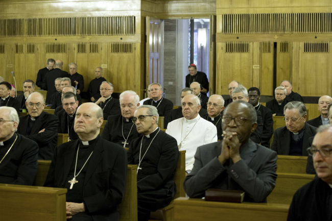 In this picture provided by the Vatican newspaper L’Osservatore Romano, Pope Francis (in white) attends a retreat outside Rome, Sunday.   AP-Yonhap