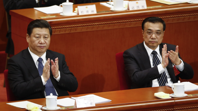 Chinese President Xi Jinping (left) and Premier Li Keqiang applaud as they attend the third plenary session of the National People’s Congress at the Great Hall of the People in Beijing on Monday.   AP-Yonhap