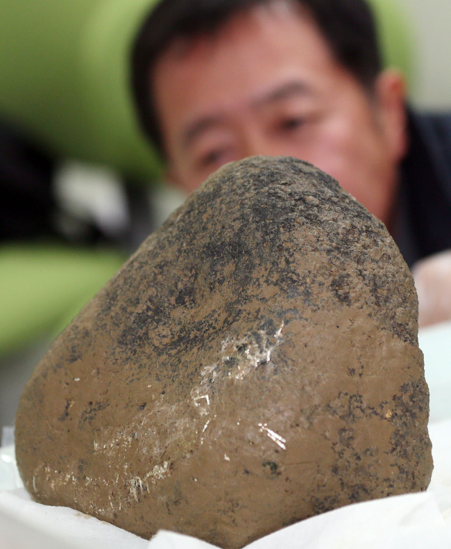 This mysterious rock found in Jinju, South Gyeongsang Province, Monday is thought to be a meteorite.    Yonhap