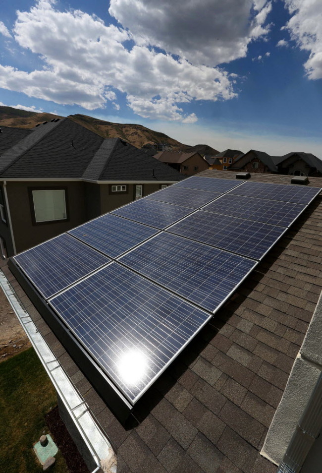 Solar electric panels sit on the roof of a Garbett Homes house in the U.S. that produces as much energy as it consumes.   Bloomberg