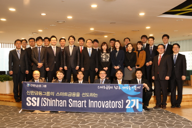 Members of Shinhan Financial Group’s latest team of Shinhan Smart Innovators pose during a launch ceremony at the group’s headquarters in Seoul on Wednesday.   Shinhan Financial Group
