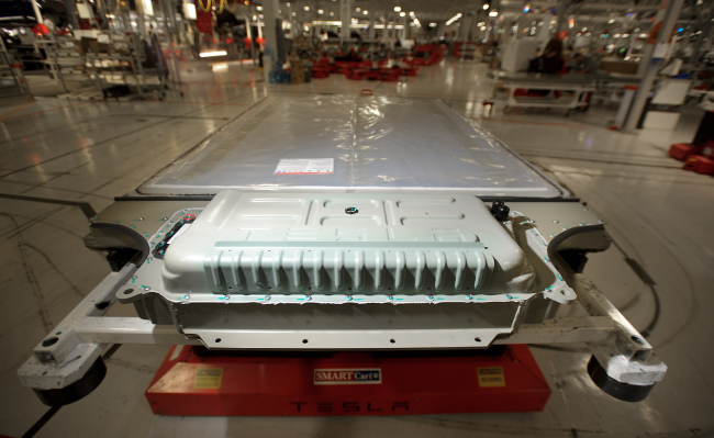 A battery awaits installation in a Tesla Model S sedan at the company’s assembly plant in Fremont, California.    Bloomberg