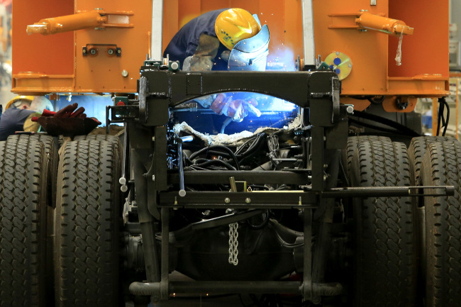 An employee welds during the manufacture of construction machinery in Sany Heavy Industry Co.’s assembly shop in Changsha, Hunan Province, China.    Bloomberg