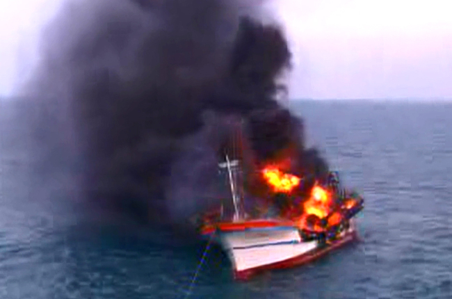 A fishing vessel burns off the coast of Jejudo Island on Monday.   Yonhap