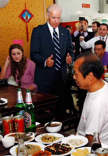 U.S. Vice President Joe Biden (center) gives a thumbs-up during lunch at Yao’s Chaogan’er Restaurant in Beijing in August 2011.   AFP