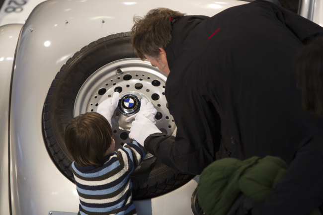 Visitors touch BMW’s vintage cars during the “Night of White Gloves” event at the BMW Museum in Munich, Germany.   BMW Group