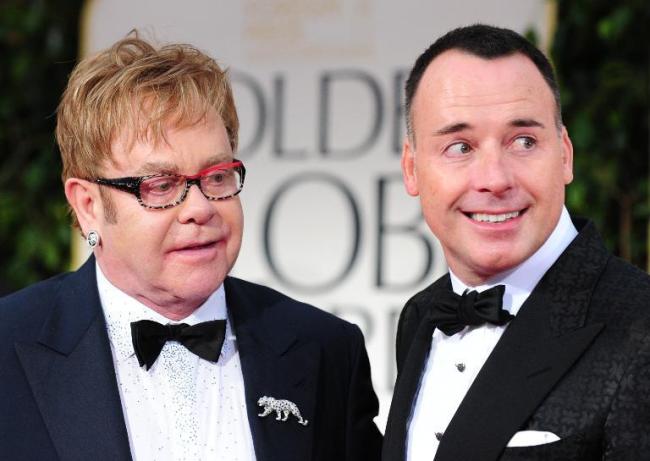 Pop icon Elton John (left) and partner David Furnish.    AFP