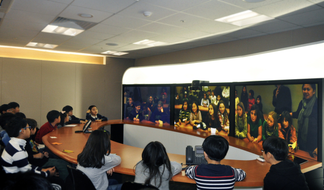 Students at Chadwick International debate with students at Chadwick School in California via a telepresence room. (Chadwick International)