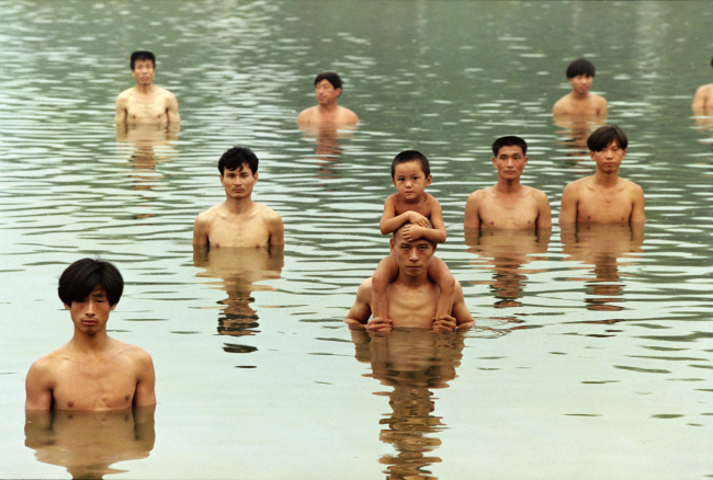 A still image from the film “To Raise the Water Level in a Fishpond” by Zhang Huan.   Total Museum