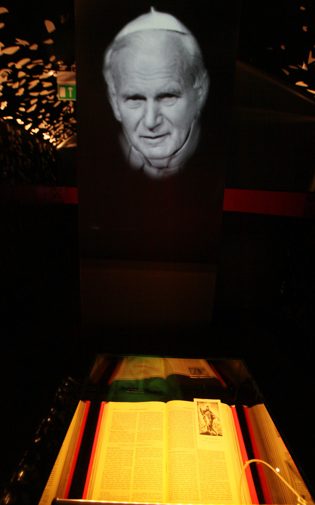 The Bible from which fragments were read to Pope John Paul II during his illness, and a portrait of the late Pope are pictured at the new multimedia museum to the pope that will open this week at his birth house in Wadowice, Poland, Monday.  AP-Yonhap
