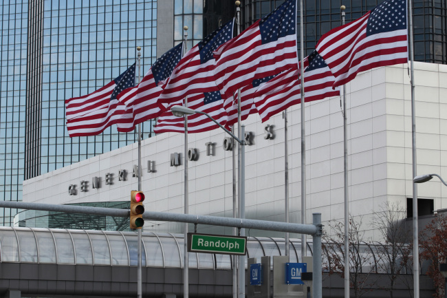 Flags fly outside General Motors’ world headquarters in Detroit.   Bloomberg