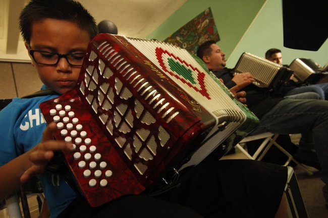 Accordion students Jason Sanchez (from left), George Magallanes and Eduardo Rocha learn a new song while Ontono Lujan, off camera, instructs them on how to play the button accordion during his weekly Saturday morning class at Plaza de La Raza in Los Angeles on March 15. (Los Angeles Times/MCT)